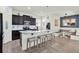 Spacious kitchen featuring a large island with seating, granite countertops, and modern appliances at 15613 Camp Dubois Cres, Winter Garden, FL 34787