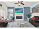 Comfortable living room featuring a modern fireplace, TV, and stylish decor at 15613 Camp Dubois Cres, Winter Garden, FL 34787
