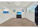 Bright living room with neutral walls and carpet, featuring a TV, coastal artwork and plenty of natural light at 15613 Camp Dubois Cres, Winter Garden, FL 34787