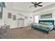 Well lit primary bedroom showcasing tropical-themed bedding and decor, and neutral walls and carpet at 15613 Camp Dubois Cres, Winter Garden, FL 34787