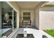 Cozy covered patio with outdoor seating and decor with sliding glass door at 15613 Camp Dubois Cres, Winter Garden, FL 34787