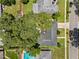 Aerial shot of a home featuring a pool, green backyard, and large trees at 1921 Geronimo Trl, Maitland, FL 32751