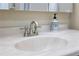 Close-up of a bathroom sink with a decorative soap dispenser on a marble countertop at 1921 Geronimo Trl, Maitland, FL 32751