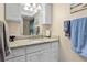 Bright bathroom featuring white cabinetry, granite countertop, and a large vanity mirror at 1921 Geronimo Trl, Maitland, FL 32751