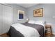 Bedroom with a gray wall, wood floors, and simple decor with an art collection at 1921 Geronimo Trl, Maitland, FL 32751