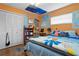 Bedroom with hardwood floors, orange walls, maps, flags, and a comfortable bed at 1921 Geronimo Trl, Maitland, FL 32751