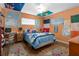 Fun bedroom with flags, maps, a ceiling fan, colorful rug and a comfortable bed at 1921 Geronimo Trl, Maitland, FL 32751