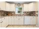 Kitchen featuring white cabinets, stainless steel appliances, and a large window at 1921 Geronimo Trl, Maitland, FL 32751