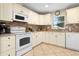 Well-lit kitchen with modern appliances, tile backsplash, and ample countertop space at 1921 Geronimo Trl, Maitland, FL 32751