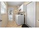 Neat laundry room features a washer and dryer with a view into a bathroom at 1921 Geronimo Trl, Maitland, FL 32751