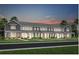 Charming townhome row with a well-manicured lawn, sidewalks, and elegant, symmetrical facade at 2025 Tohoqua Blvd, Kissimmee, FL 34744