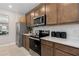Kitchen with stainless steel appliances, white backsplash, and warm wooden cabinets at 2025 Tohoqua Blvd, Kissimmee, FL 34744