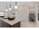 Kitchen island with quartz countertops, pendant lighting, and direct access to the staircase at 2025 Tohoqua Blvd, Kissimmee, FL 34744