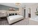 Spacious main bedroom showcasing a comfortable bed, stylish bedside tables, and access to the ensuite bathroom at 2025 Tohoqua Blvd, Kissimmee, FL 34744