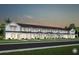 Row of townhomes in a planned community featuring modern farmhouse architecture and well-manicured lawns at 2349 Southbury Dr, Kissimmee, FL 34744