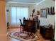 Home bar area featuring a wooden bar, seating, and decorative shelving at 2474 Cimmaron Ash Way, Apopka, FL 32703