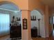 View of the bar with wooden furniture, archways and stylish decor, creating an inviting space for entertaining at 2474 Cimmaron Ash Way, Apopka, FL 32703