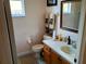 A clean bathroom with a window, vanity, and decorative towels, offering a functional space at 2474 Cimmaron Ash Way, Apopka, FL 32703