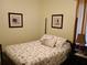 Comfortable bedroom with a queen-sized bed, framed artwork, and a bedside table with lamp at 2474 Cimmaron Ash Way, Apopka, FL 32703