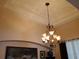Close-up of dining room chandelier highlighting the room's architectural details at 2474 Cimmaron Ash Way, Apopka, FL 32703