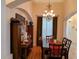 Dining area with wood floors, chandelier lighting, and a view to the foyer at 2474 Cimmaron Ash Way, Apopka, FL 32703