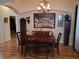 Elegant dining room with chandelier, stylish decor, and wood floors at 2474 Cimmaron Ash Way, Apopka, FL 32703