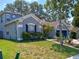 Well-manicured front yard with blue shutters and a charming blue-gray exterior at 2474 Cimmaron Ash Way, Apopka, FL 32703