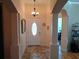 Spacious foyer with tile flooring, decorative columns, and view to other rooms at 2474 Cimmaron Ash Way, Apopka, FL 32703