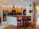 Kitchen with granite counters, stainless steel appliances, tile flooring and breakfast bar with wooden bar stools at 2474 Cimmaron Ash Way, Apopka, FL 32703