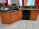 The kitchen features oak cabinetry, granite countertops, stainless steel sink, and tiled flooring at 2474 Cimmaron Ash Way, Apopka, FL 32703
