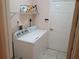Bright laundry room with a modern washing machine and dryer, plus shelving for storage at 2474 Cimmaron Ash Way, Apopka, FL 32703