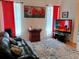 Cozy living room with leather sofa, area rug, wall art, and large windows for natural light at 2474 Cimmaron Ash Way, Apopka, FL 32703