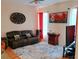 Spacious living room with leather sofa, area rug, entertainment center, and bright natural light at 2474 Cimmaron Ash Way, Apopka, FL 32703