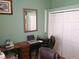 This office features a desk, mirror, sewing machine, and a chair for a productive workspace at 2474 Cimmaron Ash Way, Apopka, FL 32703