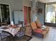 Covered patio with comfortable seating and a dining table, perfect for outdoor relaxation at 2474 Cimmaron Ash Way, Apopka, FL 32703