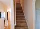 Carpeted staircase leading to the upper level, providing seamless transition in the home at 2474 Cimmaron Ash Way, Apopka, FL 32703
