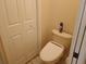 This bathroom features a toilet near a bifold door at 2474 Cimmaron Ash Way, Apopka, FL 32703