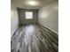 A well-lit bedroom with modern gray walls and multi-tone laminate flooring at 2520 Caper Ln # 206, Maitland, FL 32751