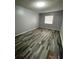 A comfortable bedroom with light gray walls and stylish multi-tone laminate flooring at 2520 Caper Ln # 206, Maitland, FL 32751