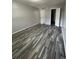 A bright bedroom with neutral walls and modern flooring, featuring two access doors at 2520 Caper Ln # 206, Maitland, FL 32751