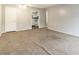 Open-concept living room featuring view into the kitchen and carpeted floors at 2520 Caper Ln # 206, Maitland, FL 32751