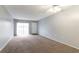 Spacious living room featuring gray walls, ceiling fan, sliding glass doors and carpeted floors at 2520 Caper Ln # 206, Maitland, FL 32751
