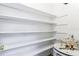 Storage space featuring water heater and white shelving at 2520 Caper Ln # 206, Maitland, FL 32751