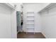 Walk-in closet featuring white walls, shelving, and carpeted floors at 2520 Caper Ln # 206, Maitland, FL 32751