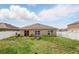 This home features a private backyard with a white fence and outdoor seating area at 267 Williamson Dr, Davenport, FL 33897
