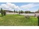 The spacious backyard features green grass, a swing set, and seating area for entertaining at 267 Williamson Dr, Davenport, FL 33897