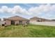 The manicured backyard is fenced and features a patio and outdoor seating area at 267 Williamson Dr, Davenport, FL 33897
