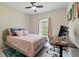 Bedroom with a pink bed, computer desk, ceiling fan, and window overlooking the backyard at 267 Williamson Dr, Davenport, FL 33897