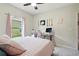 Bedroom featuring a pink bed, computer desk, ceiling fan, and a bright window at 267 Williamson Dr, Davenport, FL 33897