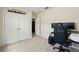 Bedroom including a gaming chair, a desk with monitors, and closet storage at 267 Williamson Dr, Davenport, FL 33897
